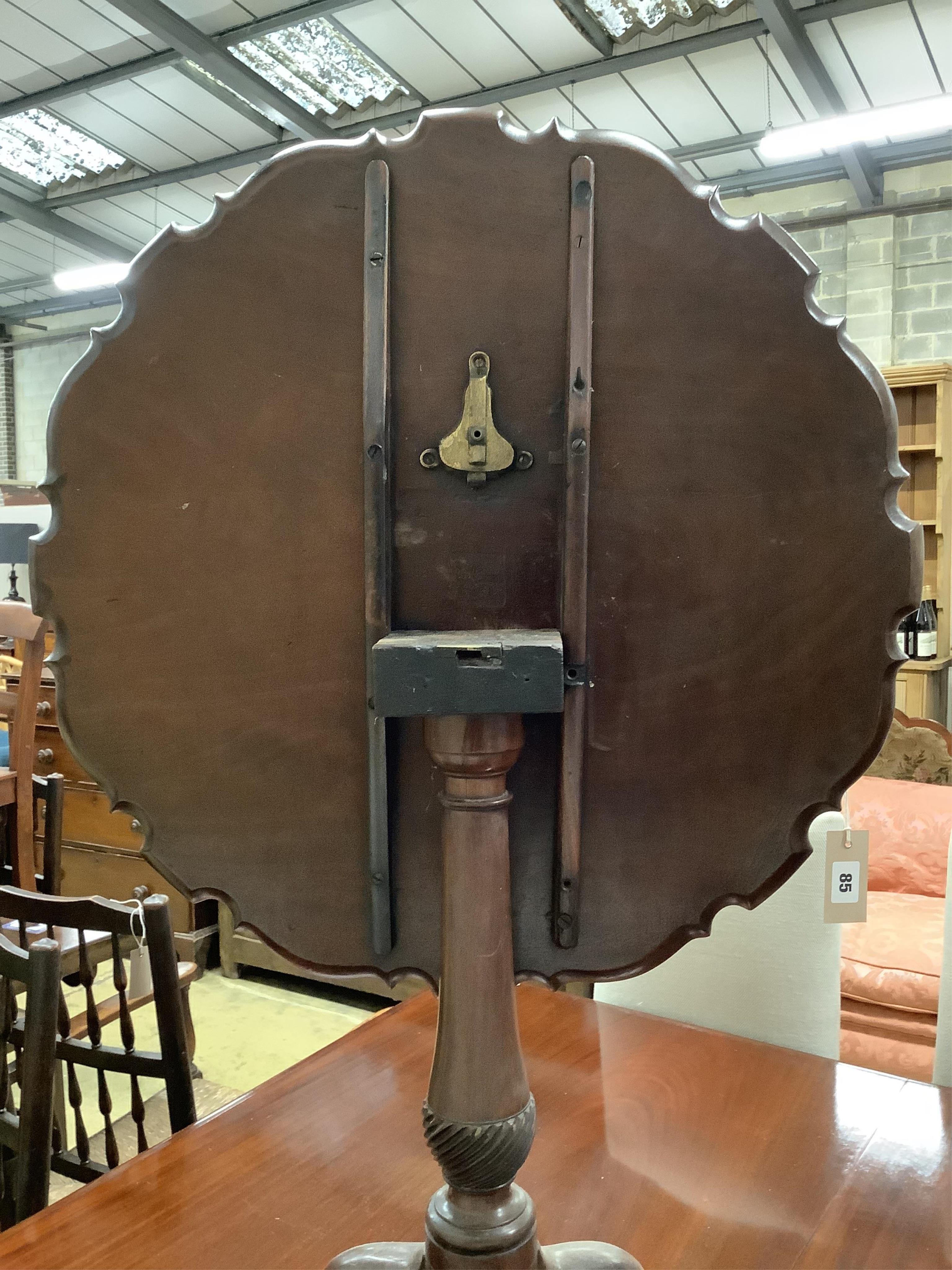 A George III circular mahogany piecrust tilt top tripod tea table, diameter 66cm, height 69cm. Condition - poor